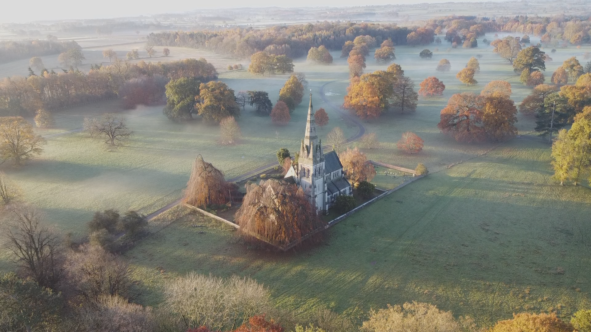 Aerial view of Christ the Consoler in misty autumn morning light, Newby Hall estate